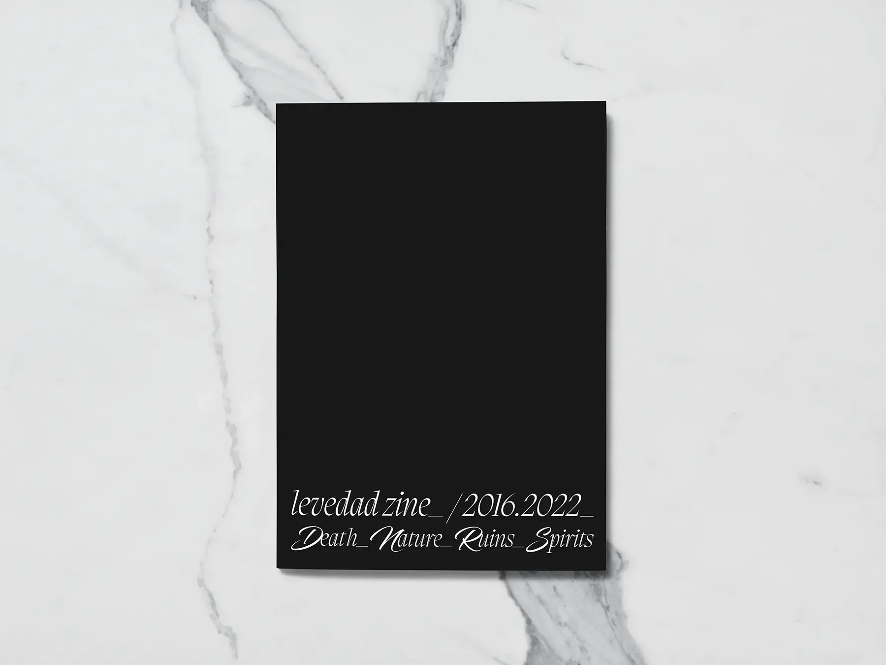 Portada negra del zine con el texto "levedad zine_ / 2016.2022_ Death_Nature_Ruins_Spirits" sobre mármol